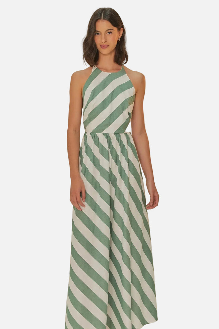 Woman wearing a green and white striped jumpsuit on a beige background