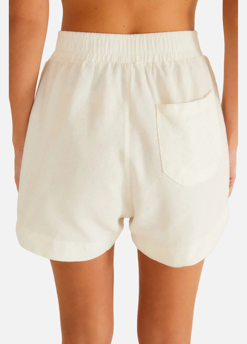 White shorts worn by a person on a white background