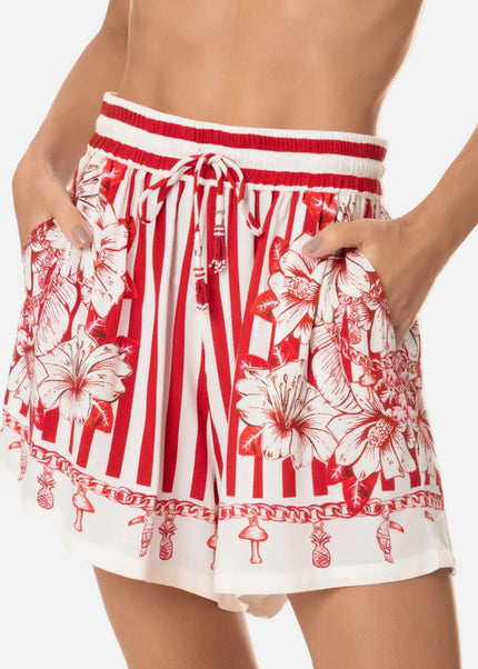 Red and white floral and striped shorts on a white background