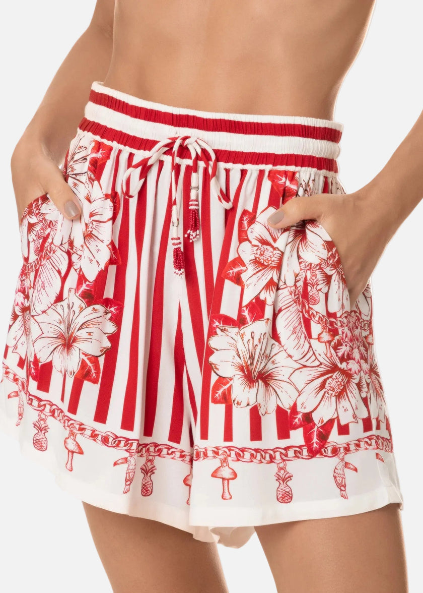 Red and white floral and striped shorts on a white background