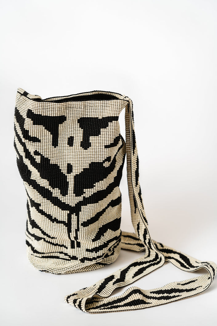 Mochila de cuentas hecha a mano con Shakiras en blanco y negro que forman un patrón de cebra