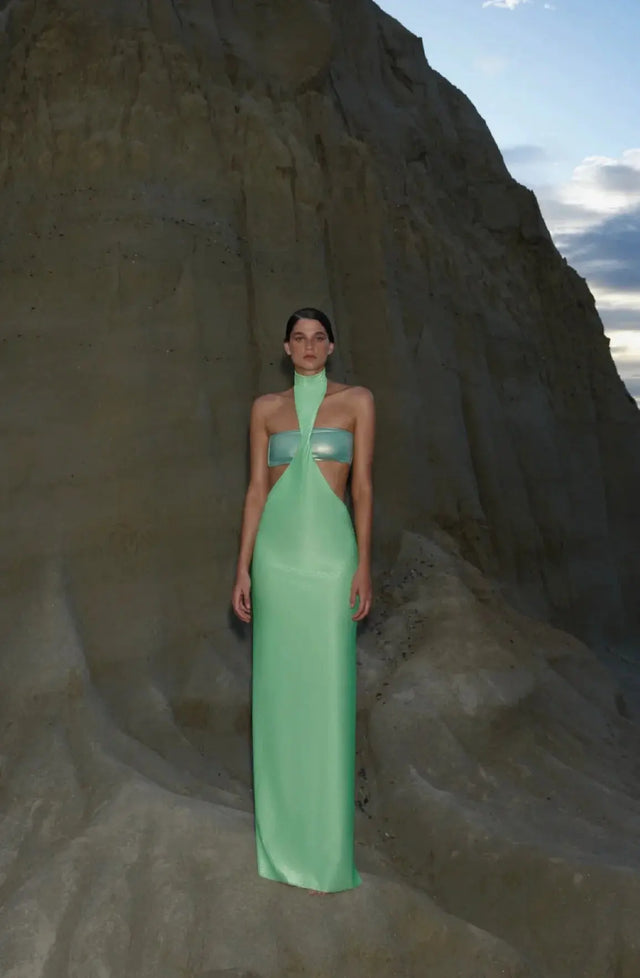 Side view of the lime green Aluna Dress, emphasizing the sleek silhouette and asymmetrical hemline