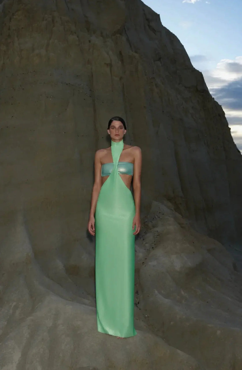 Side view of the lime green Aluna Dress, emphasizing the sleek silhouette and asymmetrical hemline