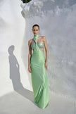 Model wearing the Aluna Dress in lime green, showcasing its one-shoulder neckline and defined side cutout.