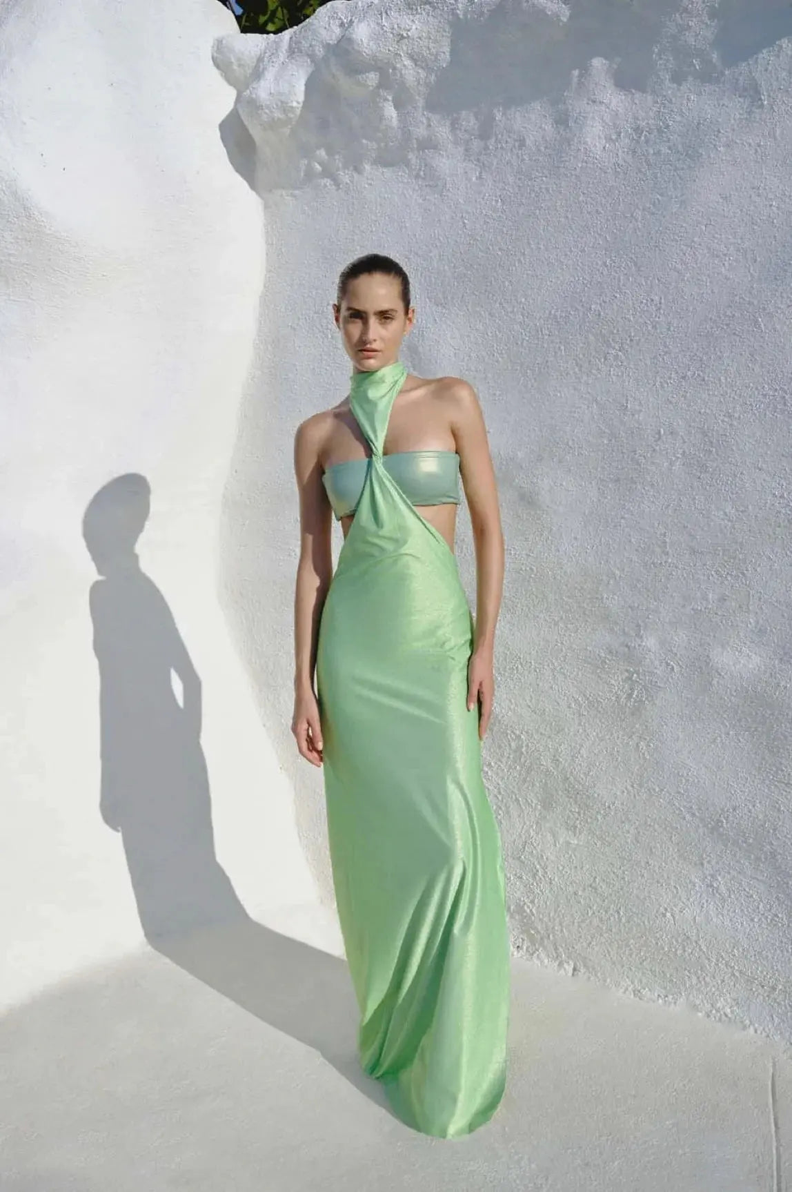 Model wearing the Aluna Dress in lime green, showcasing its one-shoulder neckline and defined side cutout.