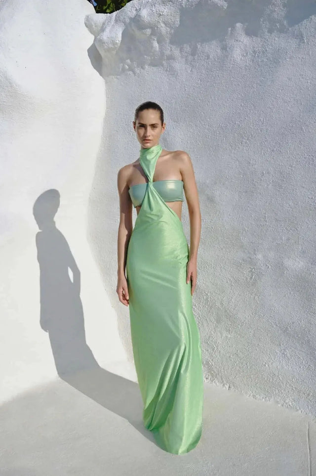Model wearing the Aluna Dress in lime green, showcasing its one-shoulder neckline and defined side cutout.