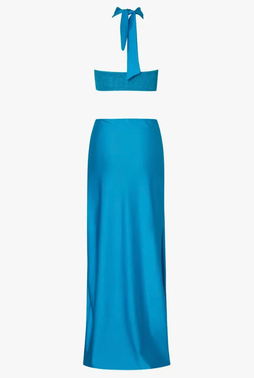 Rear view of the Aluna Dress, featuring an open back and seamless one-shoulder construction.