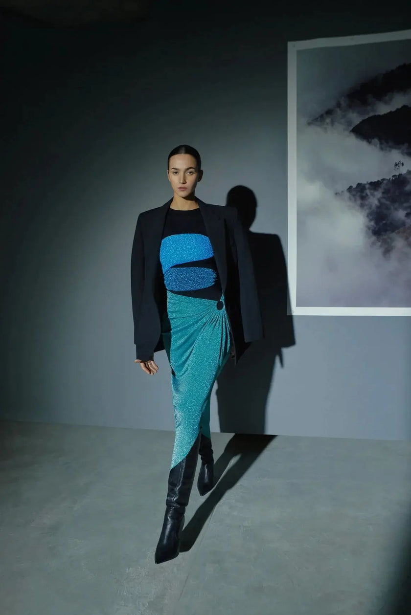 Model wearing the Natal-colored Isla Maxi Dress, showcasing its strapless design with ring-shaped details and side cutouts.