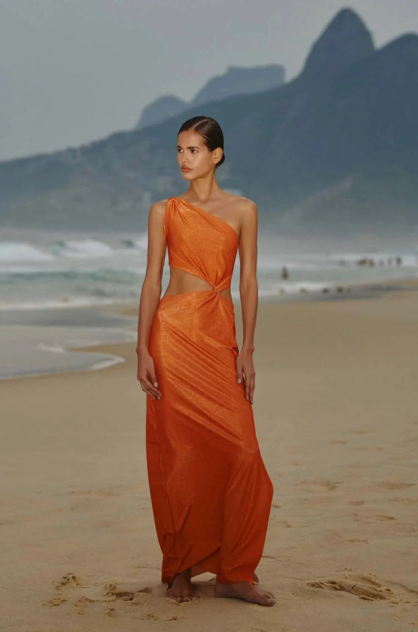 Model wearing the Durazno-colored Luana Dress, showcasing its elegant one-shoulder design and twisted top detail.