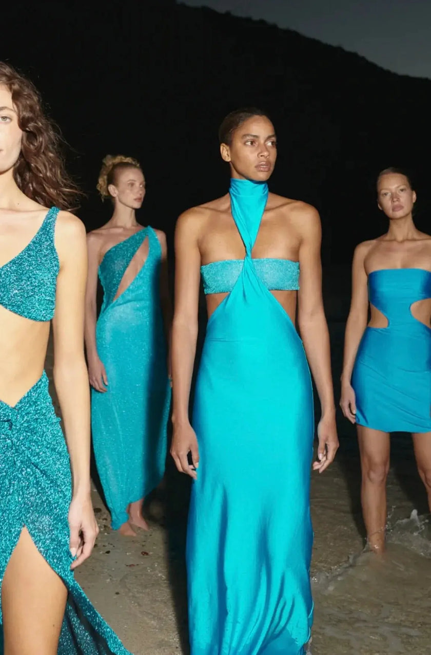 Rear view of the Mambo Asymmetric Mini Dress, revealing the seamless construction and backless style.