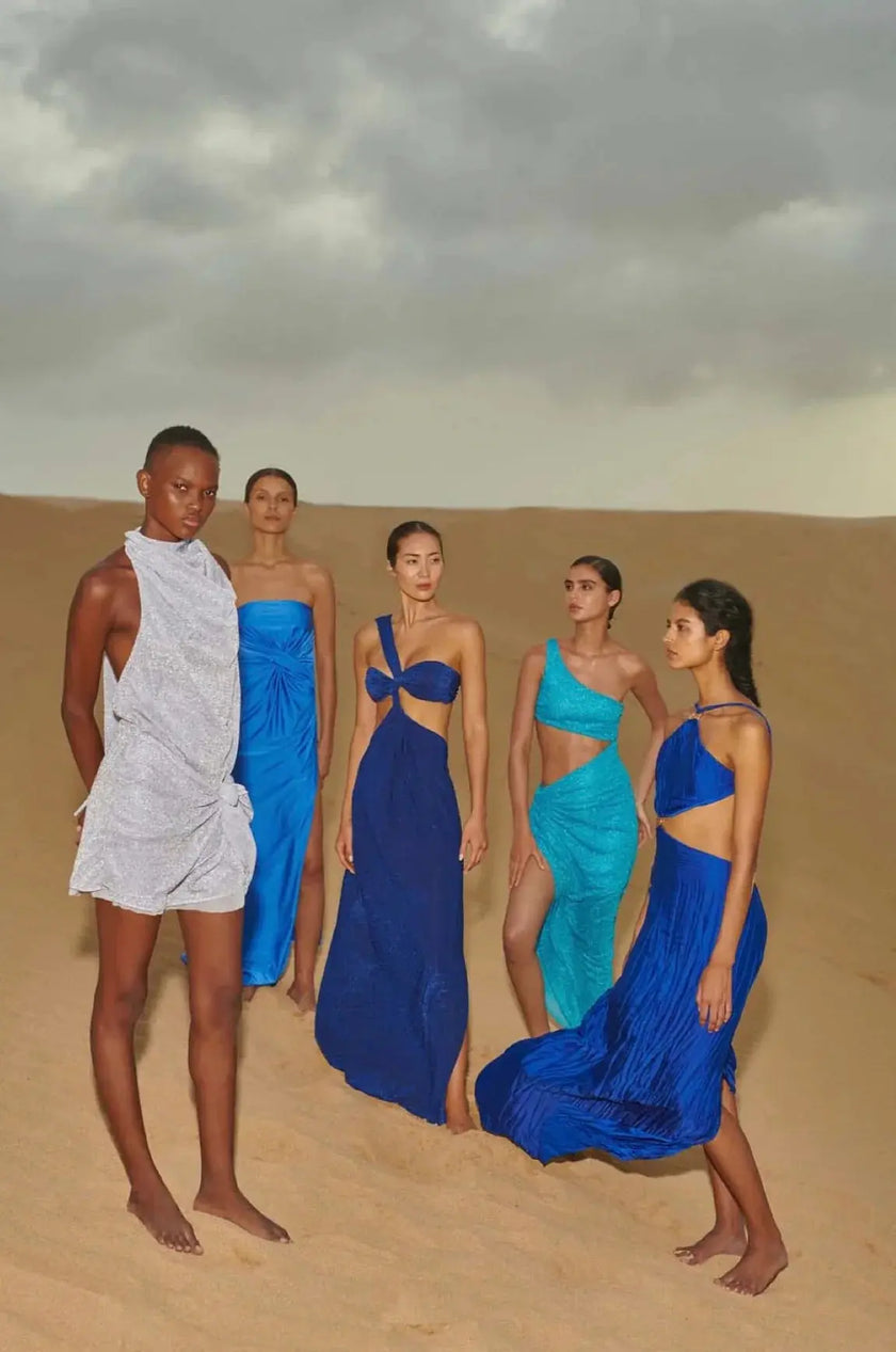 Side view of the Noah Dress in Noche Azul, emphasizing the figure-hugging fit and elegant side slit.