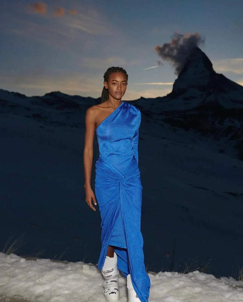 Model wearing the Noemi Dress, showcasing its off-the-shoulder design with a beautifully knotted front detail.