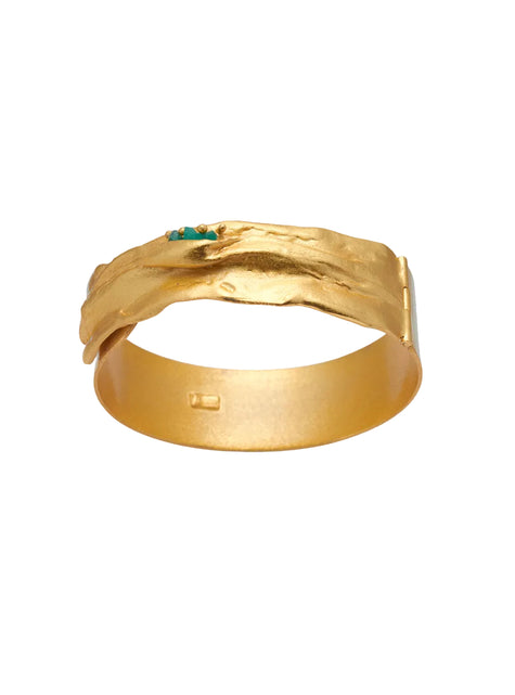 Frontal view of the Bimy bracelet showing the sculptural gold finish and small green emerald accents.