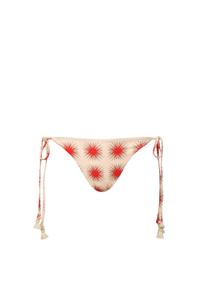 Beige bikini bottom with red starburst pattern on a white background
