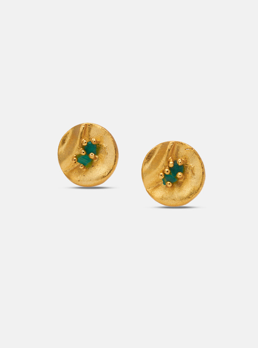 Side and back view of handcrafted circular gold earrings showcasing emerald stones and brand engraving.