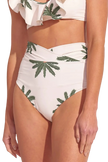 Woman wearing a tropical print bikini with a white background