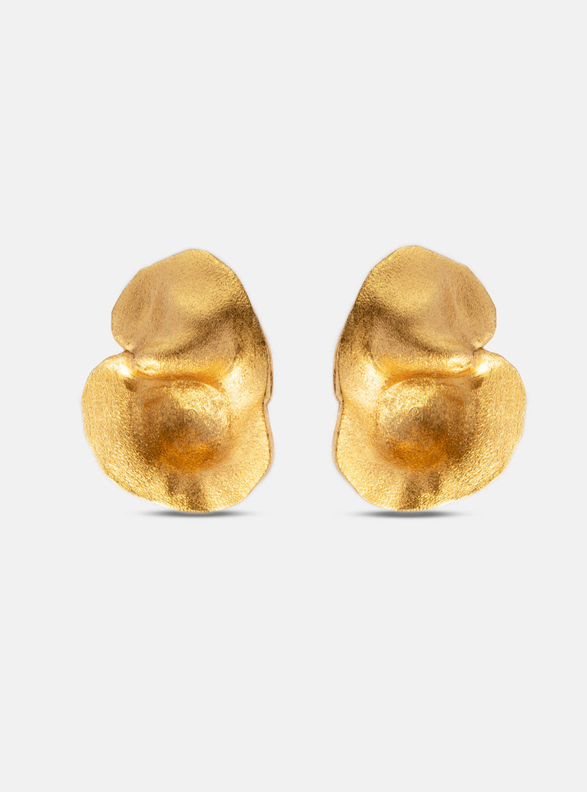 Back view of sculptural gold earrings showing their textured finish and minimalistic form.