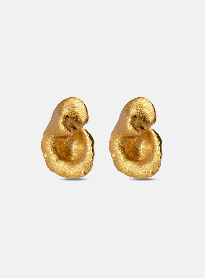 Pair of matte gold earrings with soft, curved surfaces and a fluid, asymmetrical design.