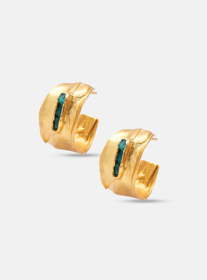 Pair of handcrafted 24k gold-plated hoop earrings with embedded raw Colombian emeralds, displayed on white background.