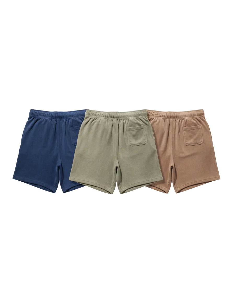 Three pairs of shorts in blue, beige, and brown on a white background