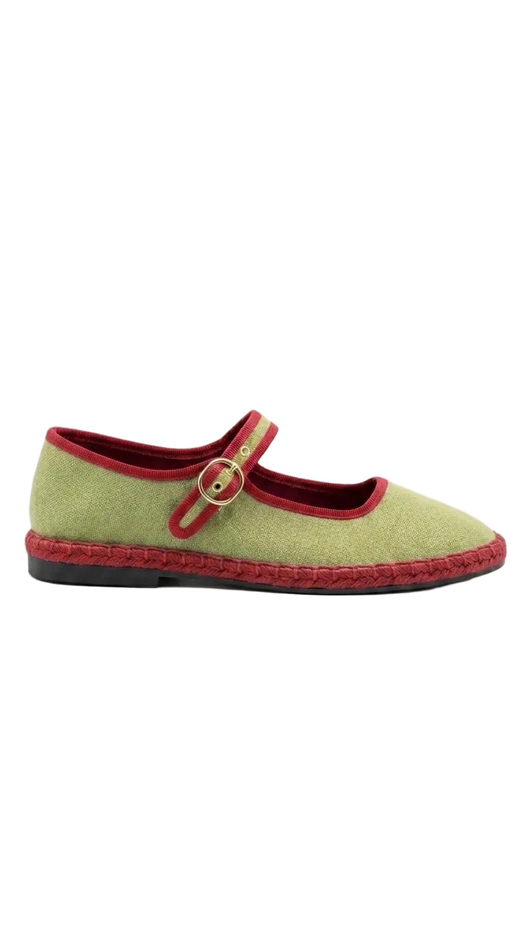 A single women's Mary Jane flat shoe in light olive green canvas with a red elastic strap, red lining, and a braided red sole, shown against a plain white background.