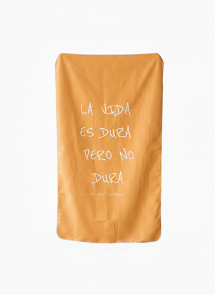 Orange towel with white text on a white background