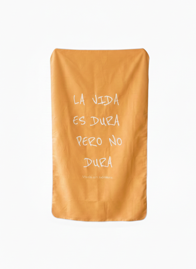 Orange towel with white text on a white background