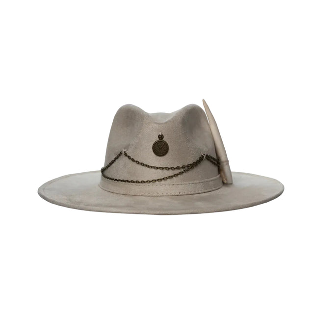 Front-facing view of the Lucky Charm hat in soft taupe suede, featuring antique bronze chains and medallion over a wide structured brim.