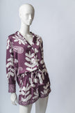Model seated on a sofa wearing the wine Lulo pajama set, radiating comfort and elegance.