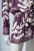 Back view of the wine Lulo set, focusing on the pant’s flow and the back of the blouse.