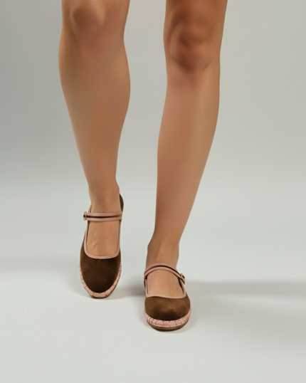 Brown sandals worn with beige tights on a white background