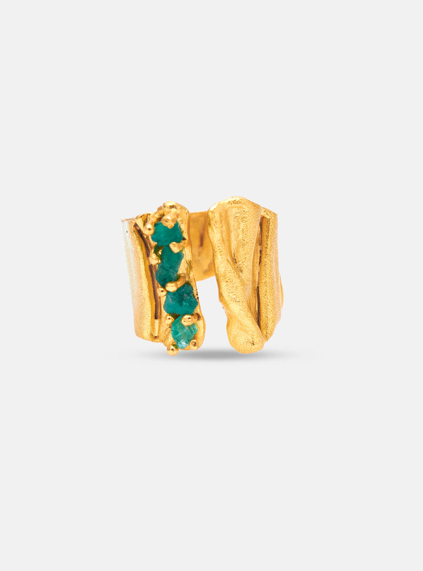 Close-up of Moky ring with four rough-cut Colombian emeralds set in organic gold shapes.
