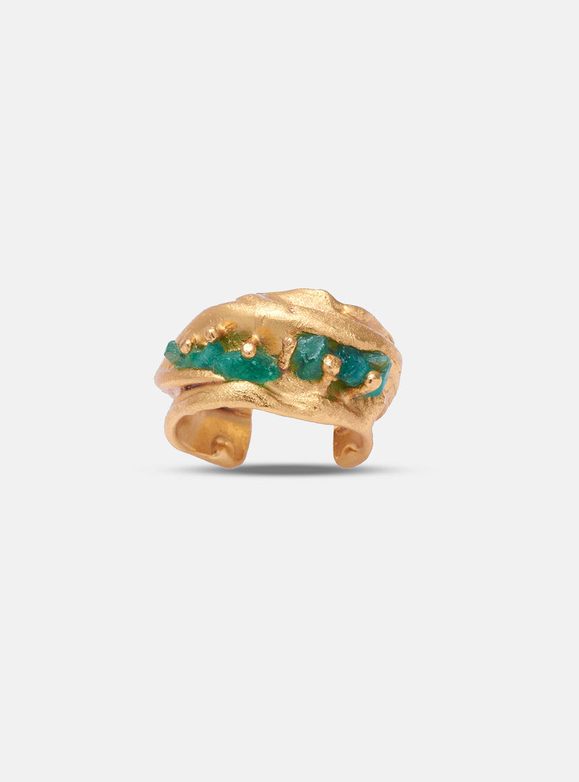 Front-facing view of the Monky earcuff showcasing natural emeralds set in gold with sculptural texture.
