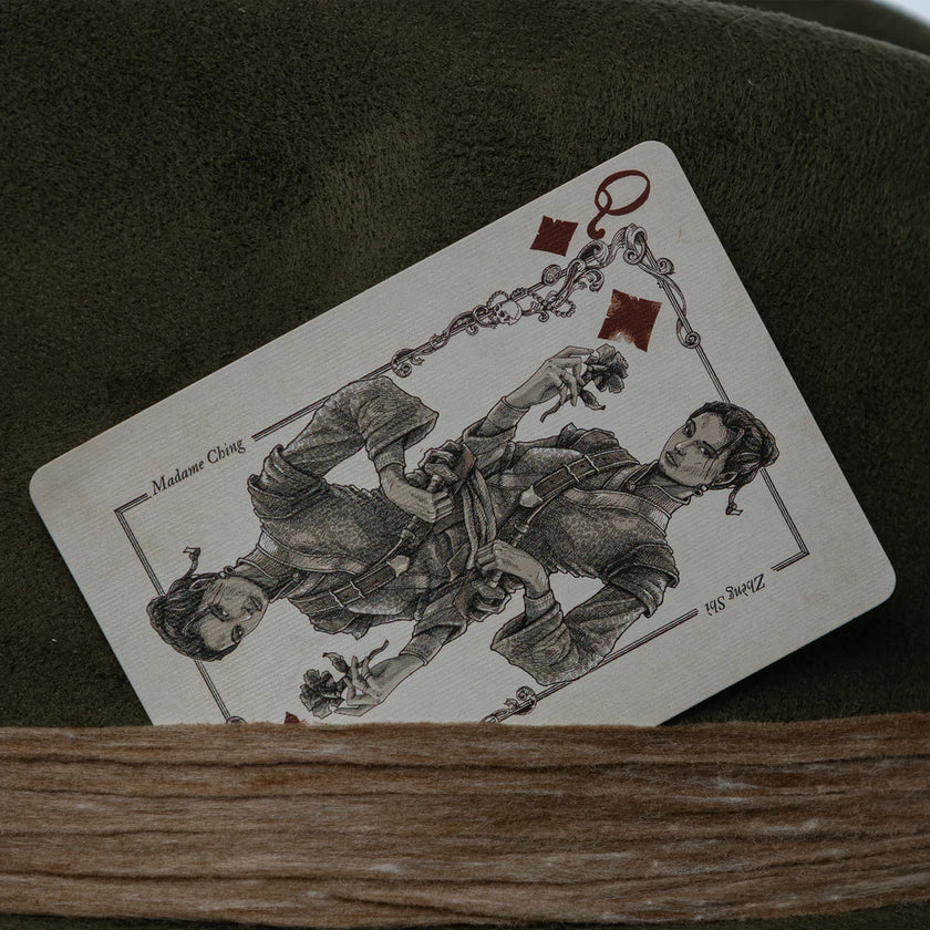 Close-up of vintage-style Queen of Diamonds playing card detail inserted in the Olive Pirates hatband, showcasing whimsical pirate theme.