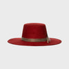 Front view of wide-brimmed red suede hat with rustic brown band, minimalist design set against a clean white background.