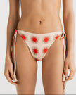 Bikini set with red starburst pattern on a white background