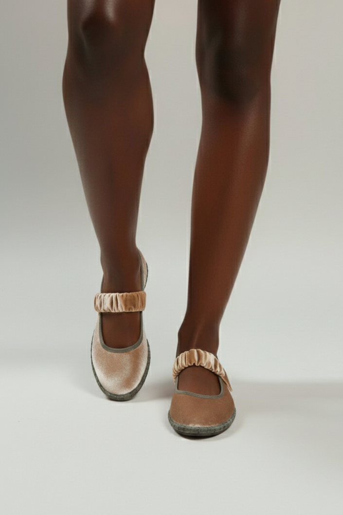 Brown shoes worn with tights on a white background