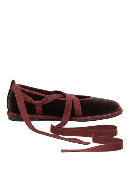 Black shoe with red laces on a white background