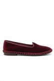 Burgundy slipper with a woven sole on a white background